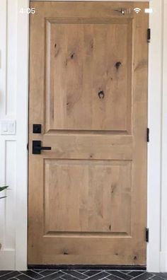 a wooden door sitting next to a potted plant