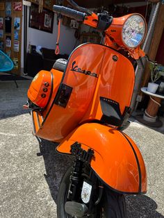 an orange scooter parked in front of a store