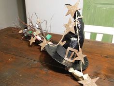 a wooden table topped with a witches hat and stars