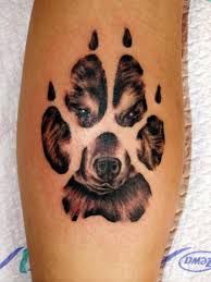 a dog's paw tattoo is shown on the side of a person's leg