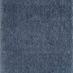 a blue rug with small dots on it