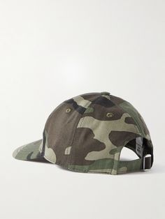 CELINE HOMME's baseball hat is patterned with a cool, camo-print and embroidered with the house's moniker across the front. Made from cotton-twill, it's built with air-ventilating eyelets on top and an adjustable strap at the back. Wear yours to dress down a tailored pea coat or crisp suit. Cap For Men, Pea Coat, Camo Print, Baseball Hat, Mr Porter, Logo Embroidered, Cotton Twill, Printed Cotton, Camouflage