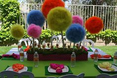 the table is set with colorful pom - poms