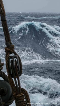 a boat in the ocean with large waves