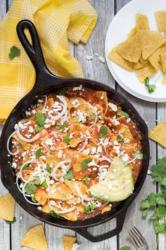 a skillet filled with tortilla chips and salsa