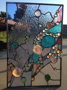 a decorative glass panel sitting on top of a sidewalk