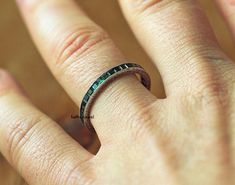 a person's hand with a ring on it