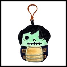 a key chain with a stuffed toy in the shape of a skeleton