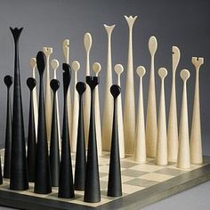 an assortment of black and white toothbrushes lined up on a chess board