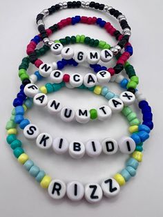 four bracelets with words on them that say, nogama, nummita, skiidz