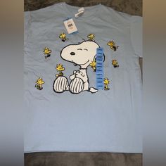 Snoopy Blue Tee New With Tags Never Worn Size L Light Blue T-shirt With Cartoon Print For Spring, Blue Cartoon Print Shirt For Spring, Casual Blue Shirt With Cartoon Print, Light Blue Cartoon Print T-shirt For Spring, Spring Light Blue T-shirt With Cartoon Print, Blue Cartoon Print Relaxed Fit Tops, Blue Relaxed Fit Top With Cartoon Print, Blue Cartoon Print Tops Relaxed Fit, Blue Cartoon Print Tops With Relaxed Fit