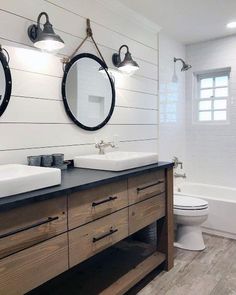 a bathroom with two sinks and mirrors on the wall