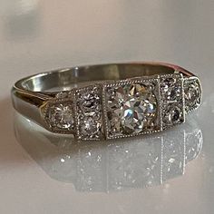 Details: Sweet vintage inspired Art Deco Style diamond and platinum step ring with just under 1 carat of diamonds! This ring has so much sparkle, and life--hard to capture in a photo but it shines bright! This ring was designed by our amazing jeweler Scott Eerkes, and lovely vintage diamonds. Would make a fabulous engagement or wedding ring! Would look great in a ring stack! This ring comes with an appraisal. Appraisal: Cut: European Carat Weight: 0.59 carat (Estimated) Measurements: 5.40 x 3.14 Classic Platinum Cluster Ring With Baguette Cut, Timeless Platinum Diamond Ring In Diamond White, Classic Emerald-cut Platinum Diamond Ring, Classic Emerald Cut Platinum Diamond Ring, Platinum Cluster Ring With Single Cut Diamonds, Art Deco Platinum Diamond Ring With Brilliant Cut, Art Deco Diamond White Round Cut Diamond Ring, Art Deco Platinum Diamond Ring With Round Cut, Art Deco Platinum Cluster Ring With Brilliant Cut