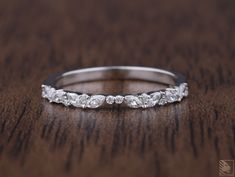 a close up of a wedding ring on a wooden surface