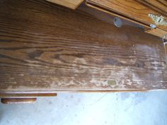 a wooden desk with some stains on it