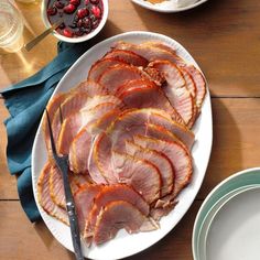 slices of ham on a plate with cranberry sauce