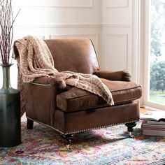 a living room with a brown chair and rug