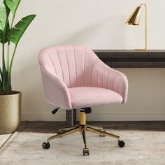 a pink office chair sitting in front of a desk with a potted plant on it