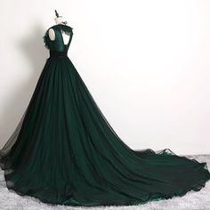 Discover timeless elegance with our Forest Green Ball Gown with Textured Ruffle Accents - Green Evening Dress with Bow Tie Belt Plus Size. This exquisite creation boasts a plunging V-neckline adorned with layered ruffle detailing, infusing classic sophistication with a modern twist. The bodice seamlessly transitions into a full, flowing skirt, layered with delicate polka dot tulle that adds depth and allure to every movement. Accentuating the waist is a stylish bow tie belt, featuring a sleek, decorative buckle that enhances the gown's exquisite craftsmanship. Perfect for exclusive galas or enchanting evening affairs, this gown combines luxurious textures and a dramatic silhouette to ensure you feel as stunning as you look. Designed to flatter every figure, it promises an impeccable fit an Dark Green Prom Dress, Victorian Style Wedding Dress, Green Ball Gown, Nontraditional Wedding Dress, Green Evening Dress, Long Formal Dress, Color Rush, Dress With Open Back, Beaded Tulle