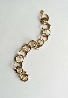 Laura Bracelet in Gold from Lie Studio. Chunky but elegant bracelet is made from gold-plated brass. Assorted rings looped together, adjustable length. Need a second opinion? If you have special requests or just need advice, please reach out to hello@shop-vestige.com. 18k Gold Plated Brass. Handcrafted in Copenhagen Gold-tone Brass Bracelets With Solid Link, Gold-tone Oval Link Brass Bracelet, Modern Brass Link Bracelets, Gold-tone Brass Bracelet With Gold Chain, Gold-tone Brass Bracelets With Gold Chain, Luxury Brass Bracelet With Adjustable Chain, Luxury Brass Bracelets With Adjustable Chain, Gold-tone Brass Link Bracelet, Timeless Gold Brass Bracelets