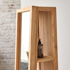 a wooden shelf with a bottle on top of it