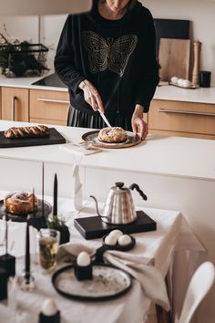 a woman is preparing food in the kitchen