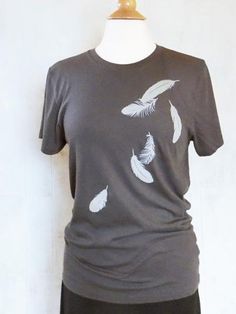 This eco-friendly womens graphic tee made of organic cotton jersey displays a picture of falling feathers screen-printed on the front. It's a very soft t shirt! It would make a great gift for a special nature-lover in your life or for yourself.Women's t-shirts and unisex t-shirts are available. Please check the measurements below.Ink: Eco friendly ink in off-white.Style: Crew NeckColor: GreyAvailable Sizes:Unisex XS, M, L, XL, 2XL (Size S will be available mid Feb.)*Please see the size chart. (t Screen Printed Tshirts, Grey Tee, Feather Dress, Mens Graphic Tee, Graphic Tees Women, Womens Tees, Tshirt Print, Long Sleeve Tshirt Men, Screen Printing