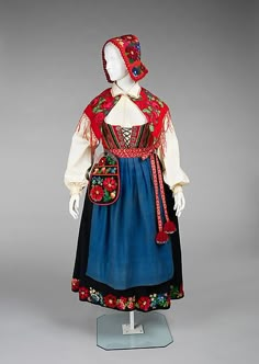 Ensemble, 1900–1915, Norwegian, wool, cotton, metal. This ensemble, known as a bunad represents the national dress of Norway. It is likely of the Rogaland variety, named for its district of origin. The form is based on traditions established in the 19th century. Bunads can be quite expensive due to the high quality of materials and craftsmanship in their construction. This example is evidence of this, especially in the handmade buttons and fine shirring of the skirt. Swedish Dress, Scandinavian Costume, Embroidery Modern, Modern Folk, Folk Dress, Folk Clothing, Unique Embroidery, National Dress, Folk Dresses