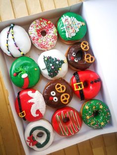 a box filled with lots of donuts covered in frosting