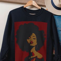 This black sweatshirt features an illustration of a beautiful black woman with voluminous afro hair, showcasing dark crimson and dark amber hues in a matte drawing style. This melanin lady exudes strength and confidence, capturing a powerful facial expression. Ideal for any situation, our unisex heavy blend crewneck sweatshirt ensures pure comfort. Made from a medium-heavy fabric blend of 50% cotton and 50% polyester, it feels cozy, making it the perfect choice for colder months. The classic fit Afro Boho Fashion, Cut Sweatshirts, Crimson Red, Black Culture, Afro Hairstyles, Brown Skin, Fashion Drawing, Cut And Style, African Print