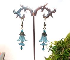 "These Art Nouveau style drop earrings feature 2 teal blue Lucite flowers, flower-like bead caps and glass crystals. They're the perfect Belle Époque or Renaissance accent for your look, day or night! They will make terrific bridesmaid gifts or wedding party jewelry. Each pair is handmade to order. ❤ SIZE: 5.1 cm (2\") drop on ear wires 4.4 cm (1.75\") drop on screw posts ❤ EAR WIRE OPTIONS: *Hook (shown) *Lever Back *Screw Post ❤ METAL/COLOR OPTIONS: *Antique Brass (shown) *Antique Copper  *Bar Whimsical Blue Jewelry With Flower Charm, Whimsical Blue Dangle Flower Earrings, Blue Whimsical Dangle Flower Earrings, Whimsical Blue Flower Earrings, Teal Blue Weddings, Lucite Flower Earrings, Copper Bar, Post Metal, Wedding Party Jewelry