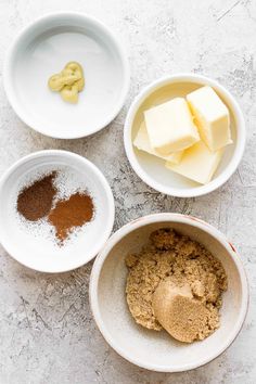 three bowls filled with different types of food on top of a white countertop next to each other