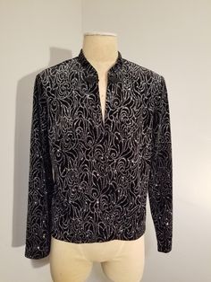 SHERI MARTIN NEW YORK CARDIGAN BLAZER JACKET  Black velvet with metallic silver glitter swirls  Built in shoulder pads Frog closure  Size 14 In excellent, vintage condition ✂ - - - Measurements laid flat: Pit to pit: 21" Waist: 19" Top to bottom: 23" Let's be friends https://www.facebook.com/TheGirlSaidYesVintage Elegant Winter Tops With Sequins, Glamorous Fitted Cardigan For Winter, Elegant Sequined Winter Tops, Elegant Winter Sequin Tops, Holiday Party Long Sleeve Cardigan, Glamorous Evening Cardigan For Winter, Glamorous Evening Winter Cardigan, Elegant Sequined Tops For Winter, Elegant Winter Cardigan With Sequins