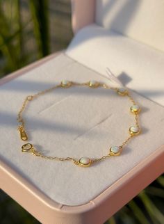 Embrace elegance with our Dainty Opal Bracelet, crafted from 100% 925 Sterling Silver. This stunning piece features a delicate round white opal bead, perfect for adding a touch of luxury to any outfit. Whether you prefer the gleam of gold or the classic shine of silver, this bracelet is a versatile addition to your jewelry collection. Item Details: Material: 100% 925 Sterling Silver Bracelet Type: Chain & Link Bracelets Opal Bead Shape/Pattern: Round Item Weight: 1g Care Instructions:  * Protect Elegant Opal Jewelry With Round Stone, Elegant Round Stone Opal Jewelry, Elegant Round Opal Jewelry, Elegant White Bracelet With Birthstone, Gold Opal Bracelet, Silver And Opal Bracelet, Adjustable Opal Bracelet For Gift, Adjustable Opal Round Bracelets, Opal Bracelet Vintage