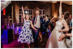 a group of people dancing at a wedding