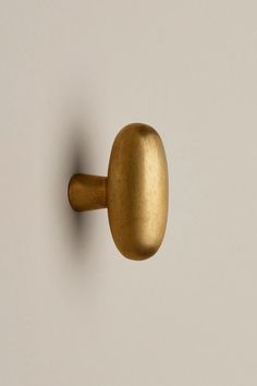 an image of a gold door handle on a white wall with no background or text