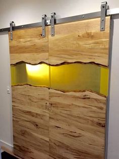 an office cubicle with sliding glass doors and wood panels