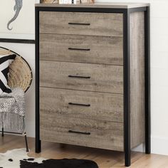 the dresser is made of wood and has black metal trimmings on the drawers