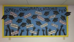 a bulletin board with graduation caps on it