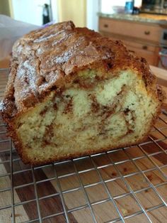 a loaf of cinnamon swirl bread cooling on a rack