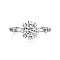 an engagement ring with a flower design on the center and side stones in white gold