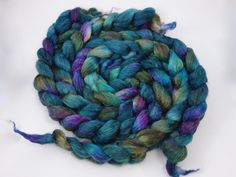 a blue and green colored yarn on white background