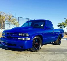 a blue truck parked in a parking lot