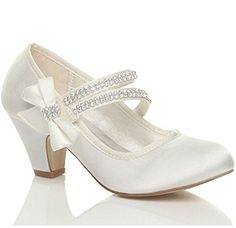 a pair of white wedding shoes with bows on the toe and heel, all in satin fabric