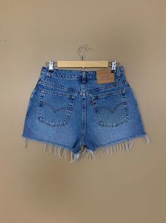 "High waisted 90's denim shorts. Made by Levi's in medium blue denim wash. Shorts are in excellent clean condition. Perfectly worn in with light naturally distressed character. Shorts have been cut off and washed once. Measurements are taken zipped or buttoned up and laid comfortably flat then x 2 for total circumference (inches) Tag Size 11 Jr 100% Cotton Made in USA Waist 30.5\" Hips 43\" Length 13\" Inseam 2.5\" Rise 11\" leg opening circumference 26\" All items are free of rips, tears, holes Levis Jeans High Waisted, Levi High Waisted Shorts, Jean Shorts High Waisted, Tommy Hilfiger 90s, Gap Denim Shorts, Vintage Levi Shorts, 90s Shorts, Tommy Hilfiger Shorts, Cutoff Shorts