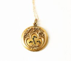 Antique Gold Filled Locket Pendant Necklace. A beautiful Art Nouveau crafted pendant. Featuring floral embossed designs and glass stones. Please note that this locket is missing one half. The frame and paper insert are still intact, so a photo still could be placed inside. This is too beautiful of a locket not to wear despite its missing piece. The gold filled chain was added by me, not vintage. Circa 1910's No markings/hallmarks Measurements: Chain is 18 inches Locket/Pendant is 1.25 inches  Go Art Deco Jewelry With Vintage Charm For Vintage Events, Vintage Charm Art Deco Jewelry For Formal Occasions, Art Deco Vintage Charm Jewelry For Formal Occasions, Formal Art Deco Jewelry With Vintage Charm, Antique Yellow Gold Necklace With Historical Design, Art Deco Jewelry With Vintage Charm For Anniversary, Antique Gold Vintage Charm Jewelry, Art Deco Vintage Charm Jewelry For Anniversary, Antique Gold Medallion Jewelry With Vintage Charm