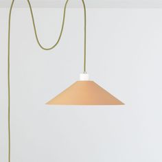 a light that is hanging from a cord in a room with white walls and flooring