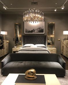 a bed room with a neatly made bed and a chandelier