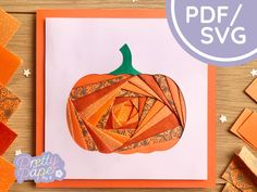 a card with an origami pumpkin cut out of paper on top of it