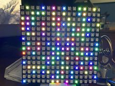 an array of multicolored leds are displayed on a desk